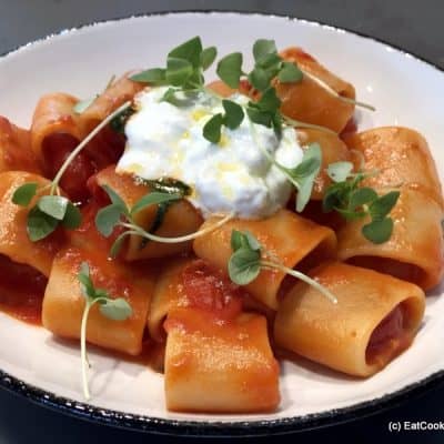 Paccheri pasta with tomato sauce and homemade stracciatella